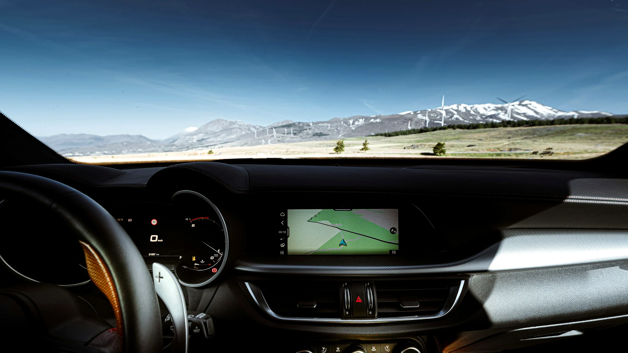 Mountains seen clearly through a car windshield