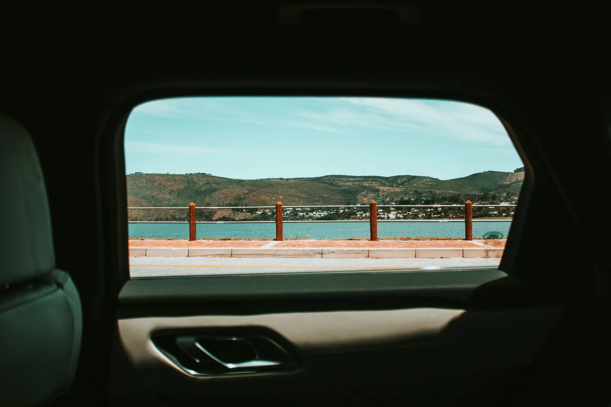 A lake view through a car's rear window