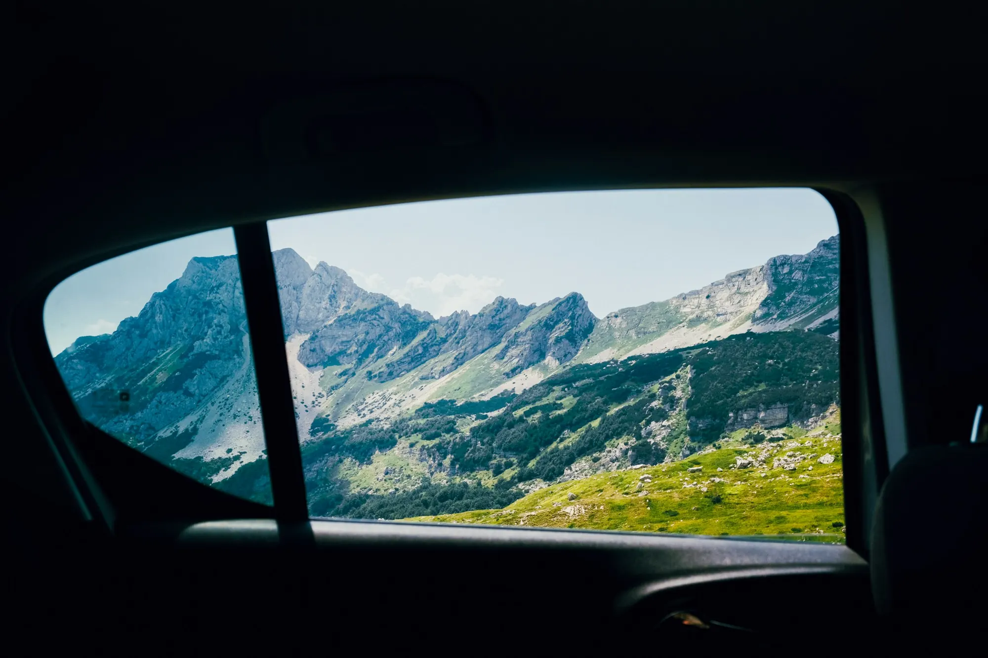 Mountains seen through a car rear window